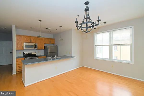 a view of a kitchen with a sink stainless steel appliances and cabinets