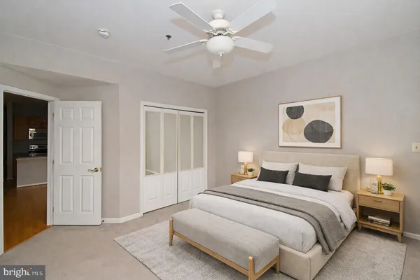 a bedroom with a large bed and a chandelier