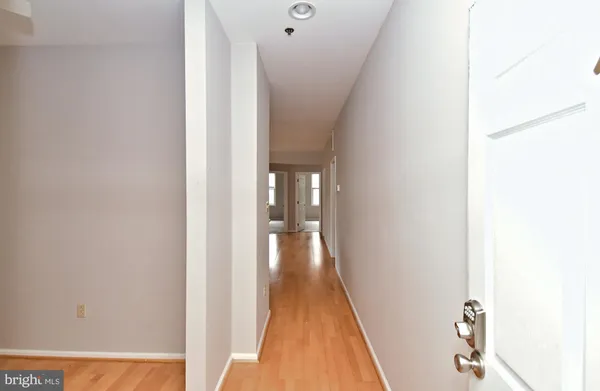 a view of a hallway with wooden floor