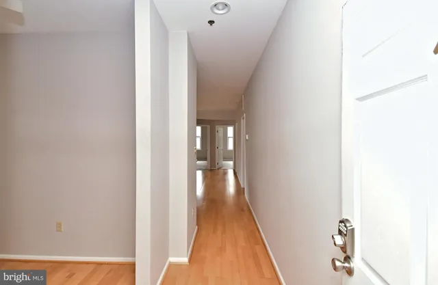 a view of a hallway with wooden floor