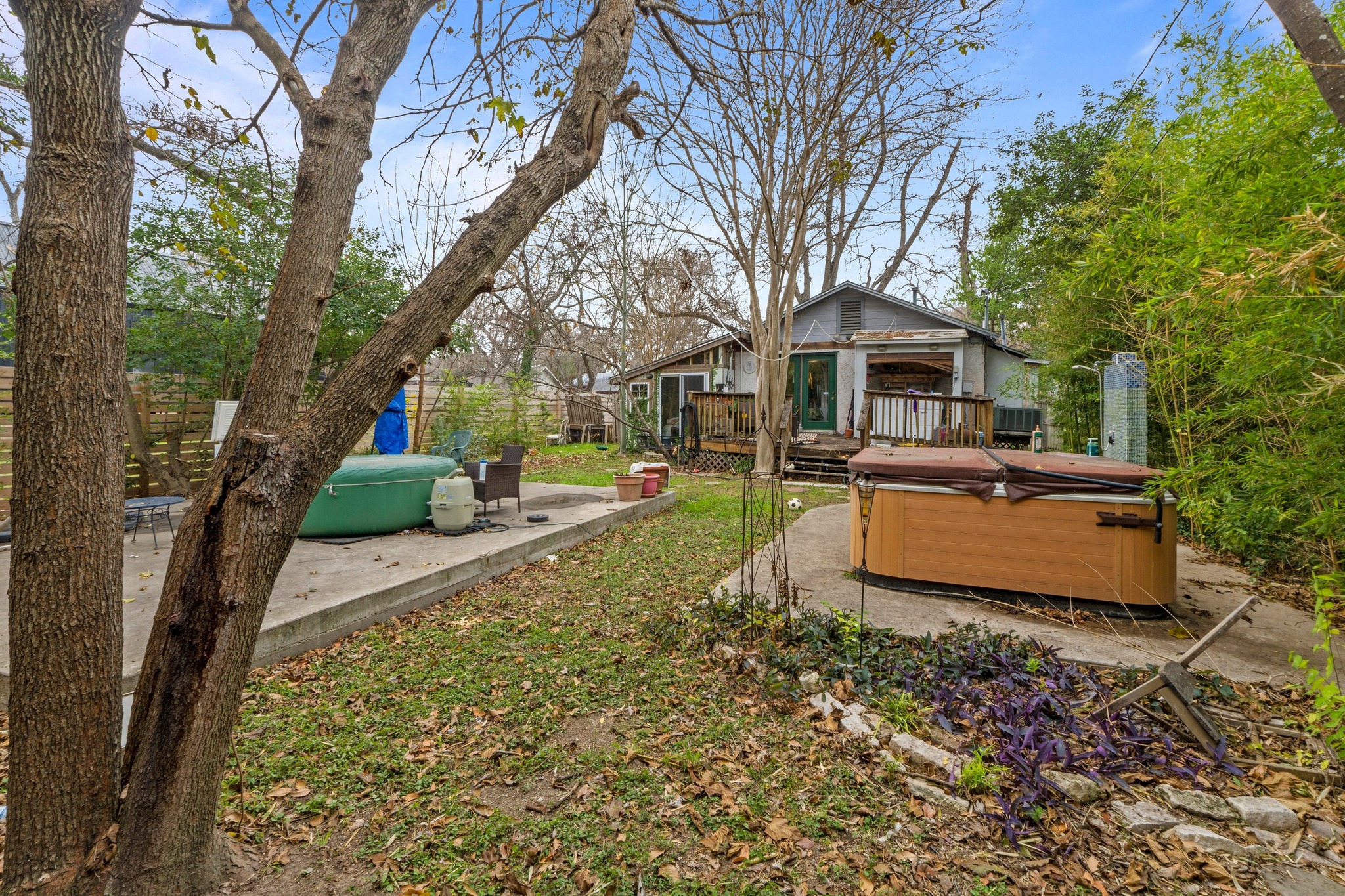 4519 Avenue D Austin, TX 78751 - Photo 8 of 18 View of yard with a hot tub, a wooden deck, and a patio area