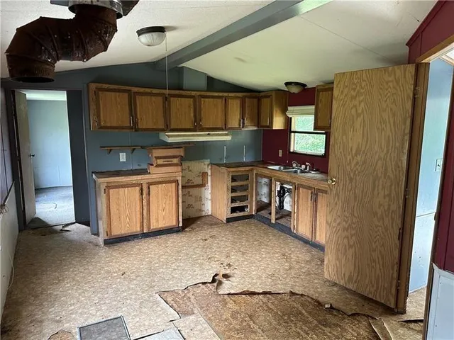 a view of kitchen with cabinets