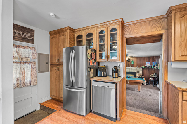 31 B Street Springville, UT 84663 - Photo 11 of 31 Wood-finish cabinetry with glass-front uppers, stainless steel French door refrigerator, and stainless steel dishwasher