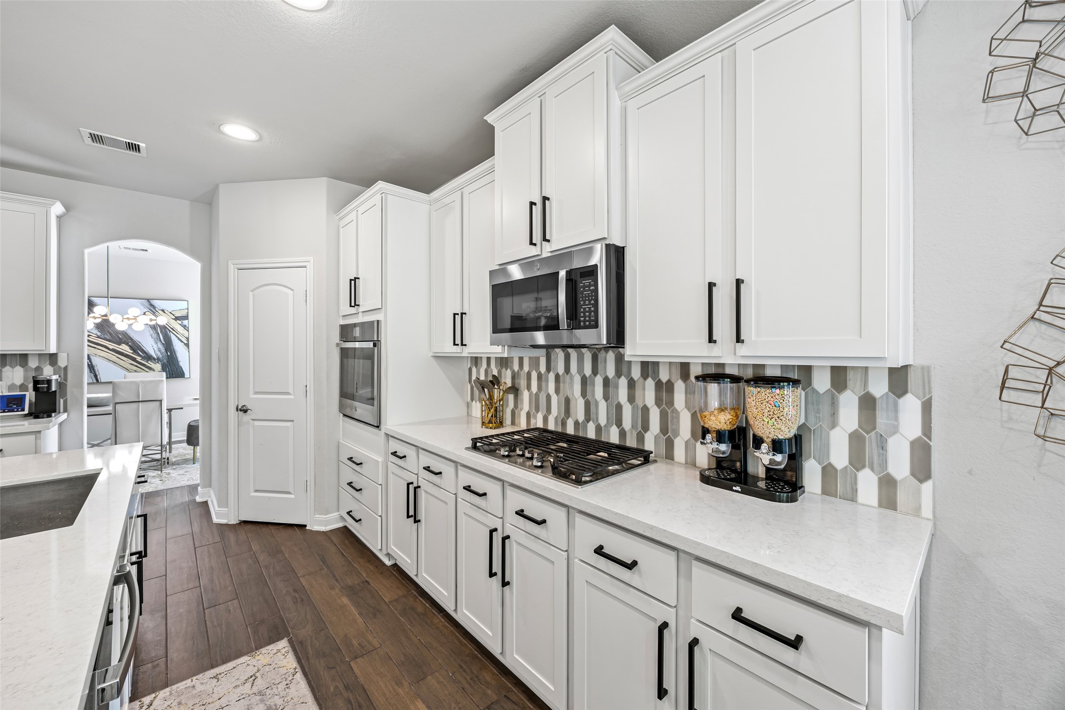 2823 Skerne Forest Drive Spring, TX 77373 - Photo 18 of 43 a kitchen with stainless steel appliances a stove a sink a refrigerator and cabinets