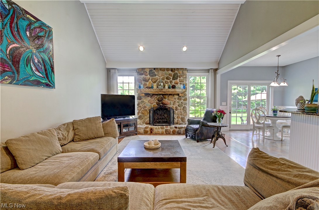 33900 Detroit Road Avon, OH 44011 - Photo 13 of 29 Living room featuring a high ceiling, lofted ceiling, a fireplace, and light tile floors