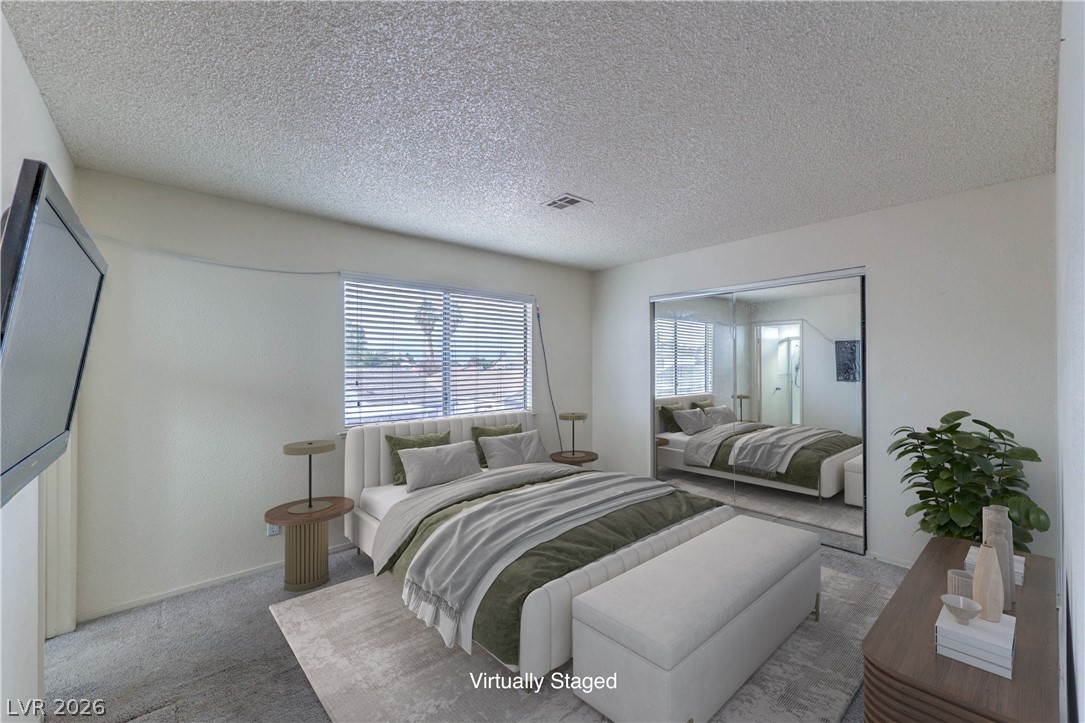 581 Carleton Drive Henderson, NV 89014 - Photo 14 of 37 Well-lit bedroom with mirrored closet doors and a window providing natural light.