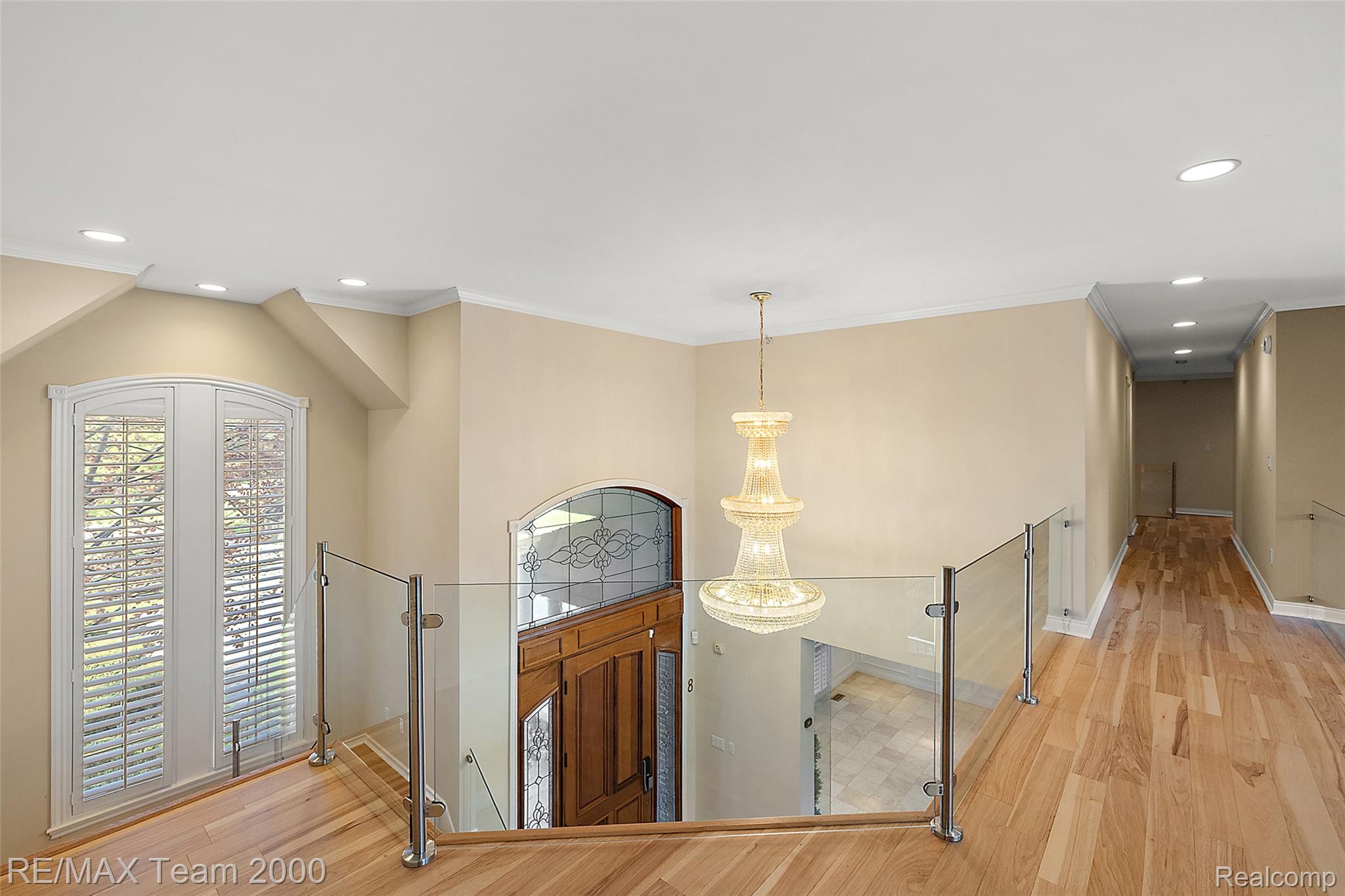 630 Sheldon Court Rochester, MI 48306 - Photo 53 of 94 Corridor with light wood finished floors, an upstairs landing, and suspended lighting