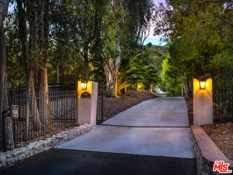 2069 Cold Canyon Road Calabasas, CA 91302 - Photo 3 of 34 a backyard of a house with table and chairs