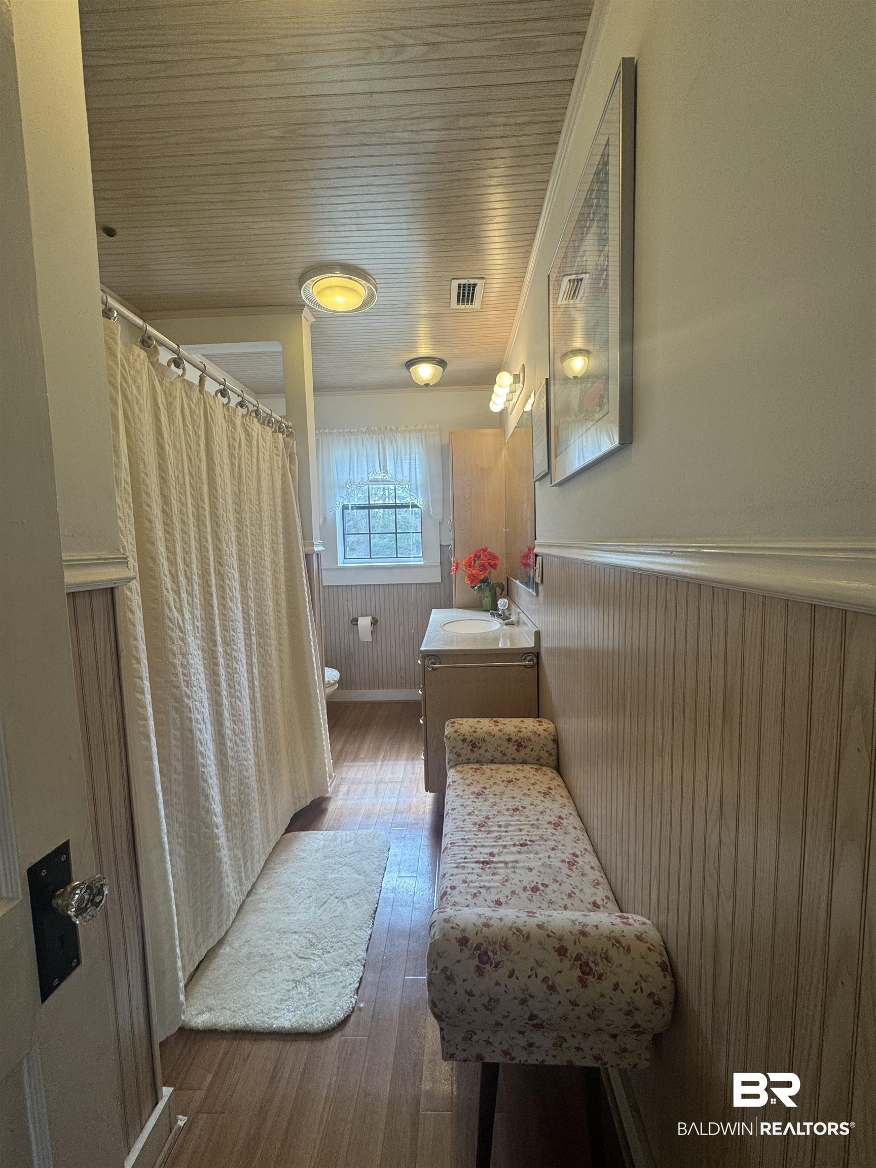 275 Thames Road Frisco City, AL 36445 - Photo 20 of 24 Full bathroom featuring toilet, hardwood / wood-style flooring, a wainscoted wall, vanity, and visible vents