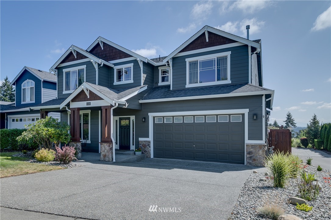 21105 1st Avenue West Bothell, WA 98021 - Photo 1 of 40 a front view of a house with a yard and garage