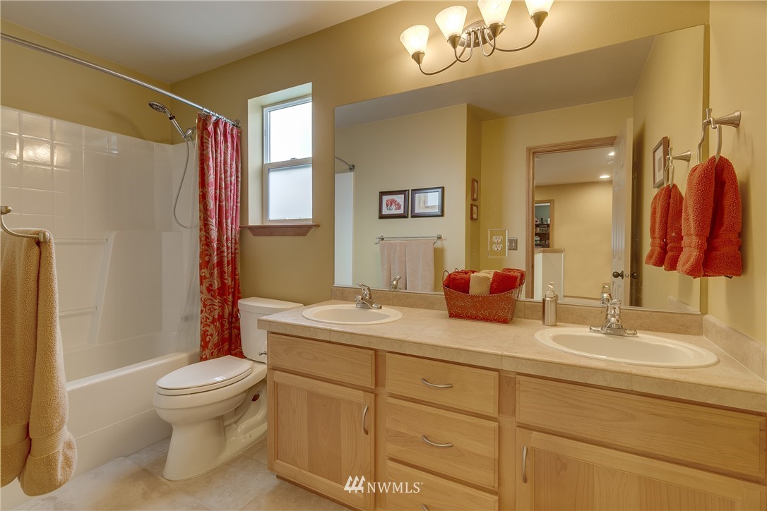 21105 1st Avenue West Bothell, WA 98021 - Photo 11 of 40 a bathroom with a sink a toilet a mirror a vanity and shower