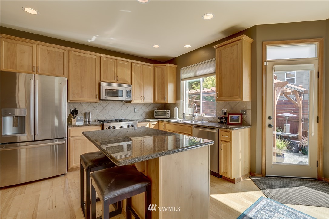 21105 1st Avenue West Bothell, WA 98021 - Photo 12 of 40 a kitchen with a refrigerator a sink and cabinets
