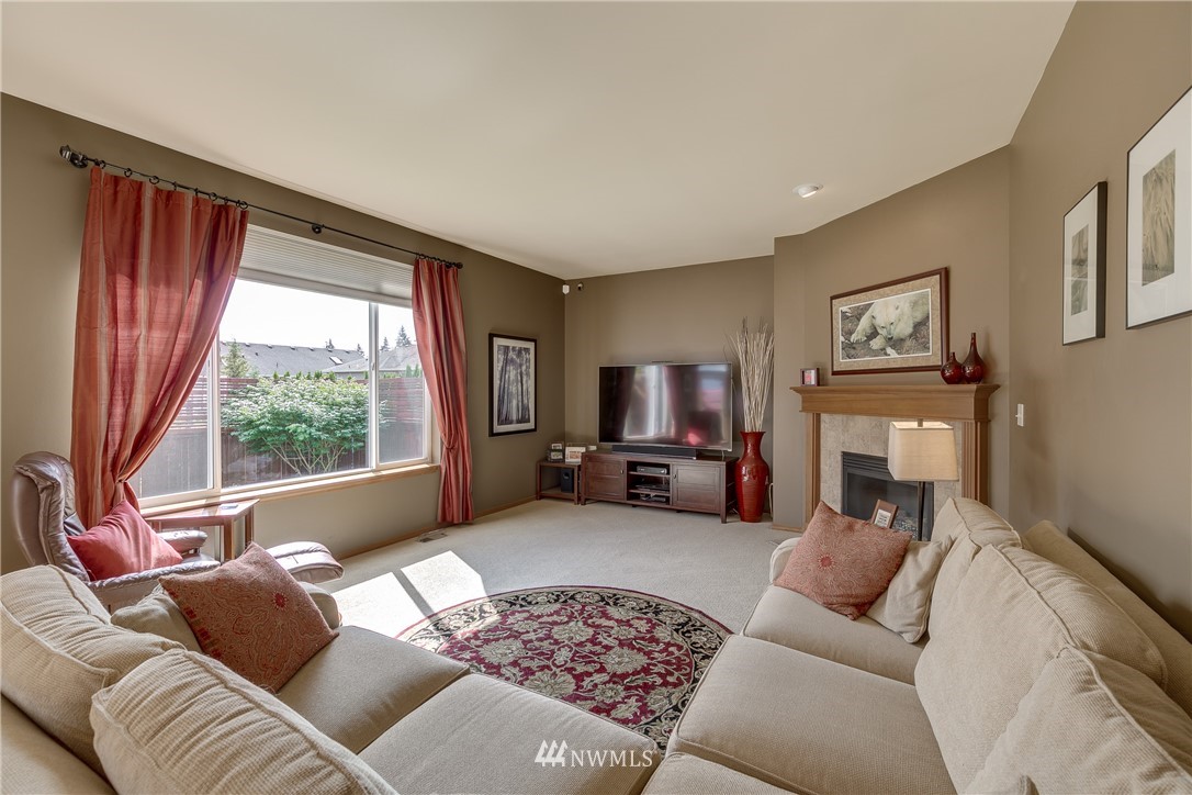 21105 1st Avenue West Bothell, WA 98021 - Photo 17 of 40 a bed room with furniture a fireplace and a large window