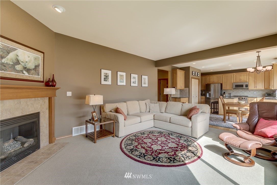 21105 1st Avenue West Bothell, WA 98021 - Photo 19 of 40 a living room with furniture a dining table and a fireplace