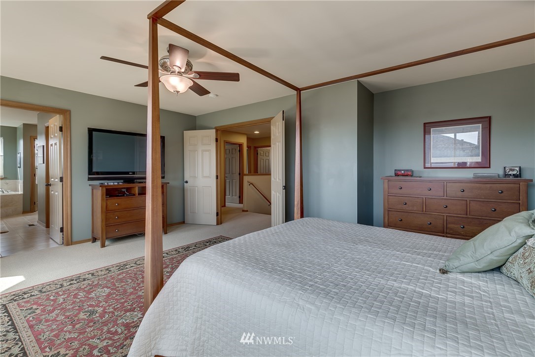 21105 1st Avenue West Bothell, WA 98021 - Photo 23 of 40 a bedroom with a bed and a television in it
