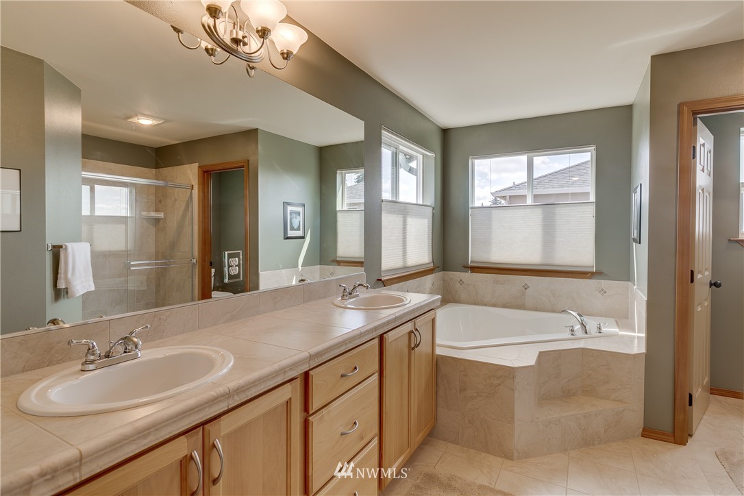21105 1st Avenue West Bothell, WA 98021 - Photo 25 of 40 a spacious bathroom with a sink double vanity granite tub shower and a mirror