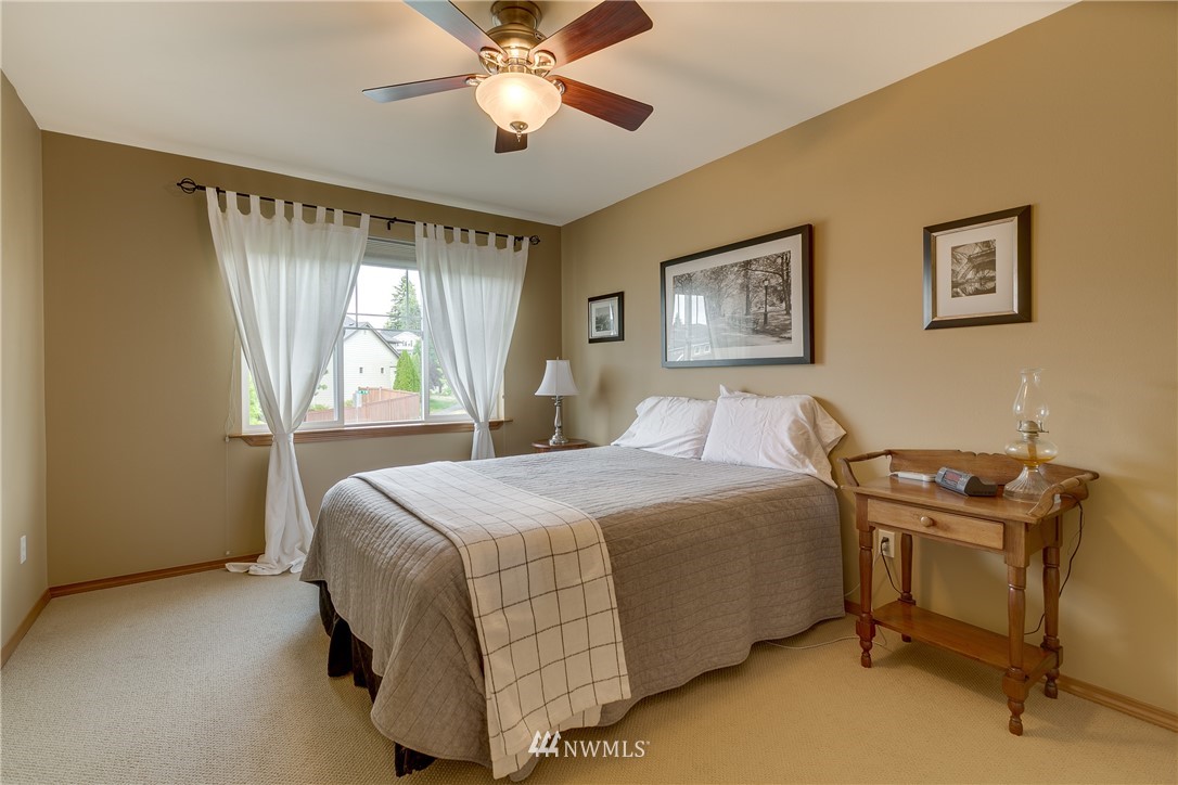 21105 1st Avenue West Bothell, WA 98021 - Photo 28 of 40 a bedroom with a bed and a chandelier