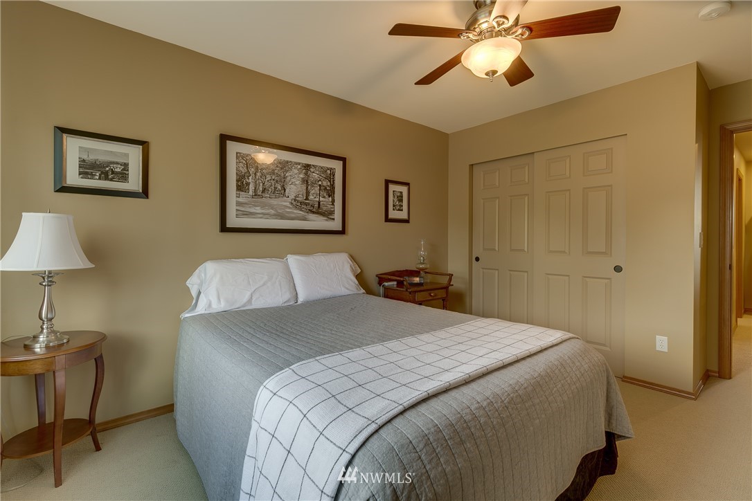 21105 1st Avenue West Bothell, WA 98021 - Photo 29 of 40 a bedroom with a bed and a chandelier