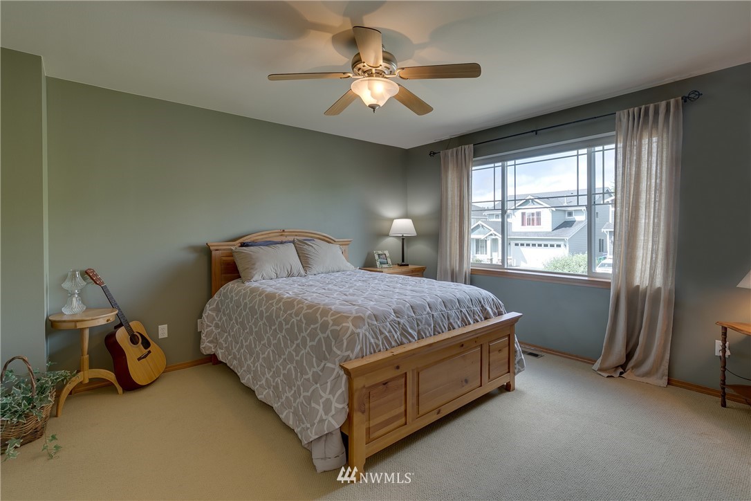 21105 1st Avenue West Bothell, WA 98021 - Photo 31 of 40 a spacious bedroom with a bed and a chandelier