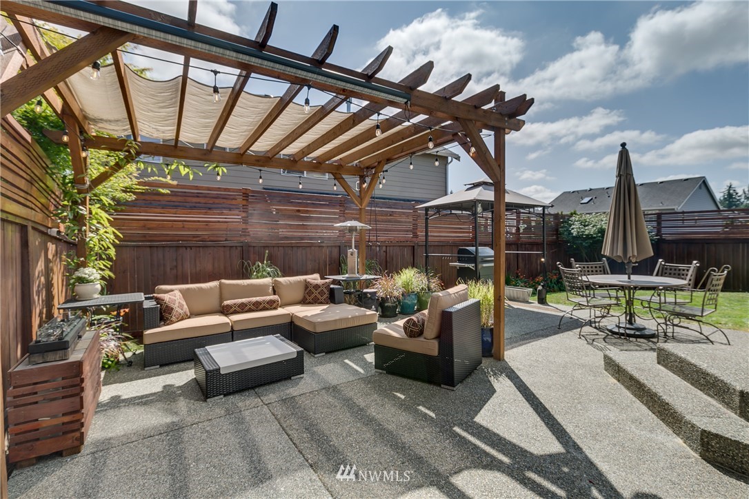 21105 1st Avenue West Bothell, WA 98021 - Photo 33 of 40 a patio with patio couch and a fireplace