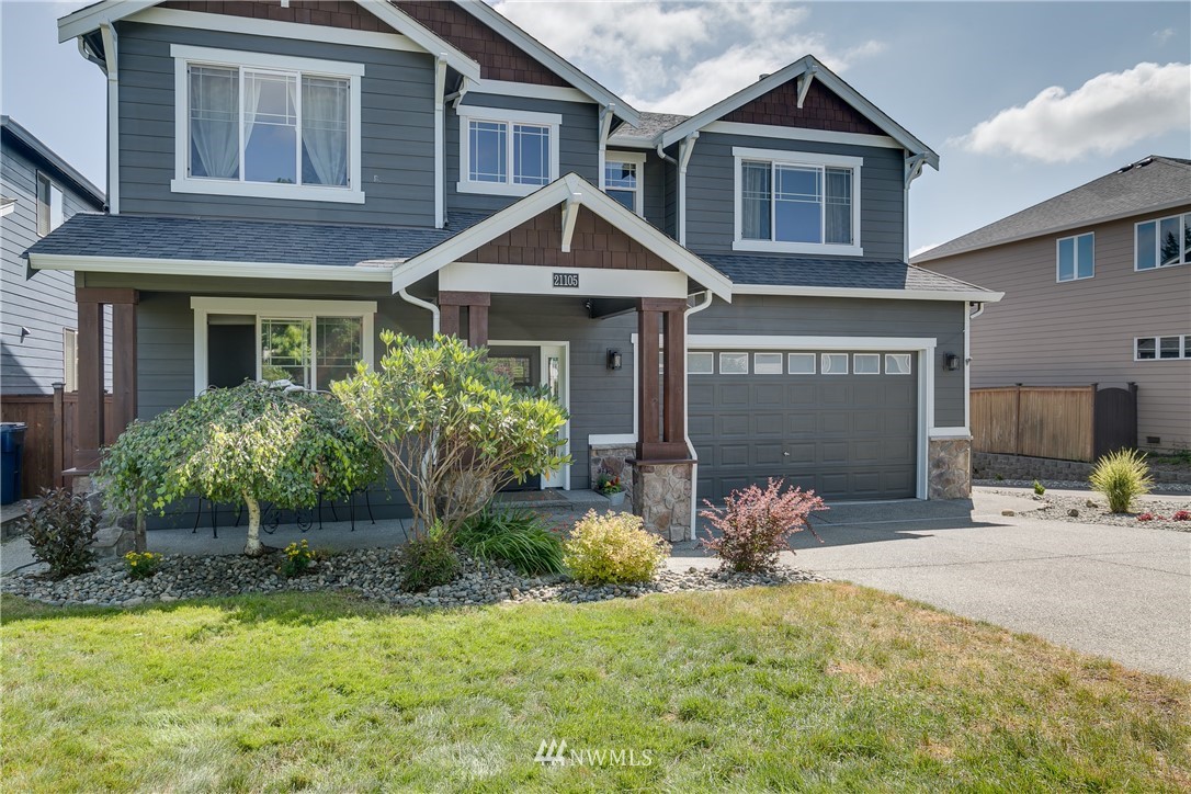 21105 1st Avenue West Bothell, WA 98021 - Photo 39 of 40 a front view of a house with a yard and potted plants