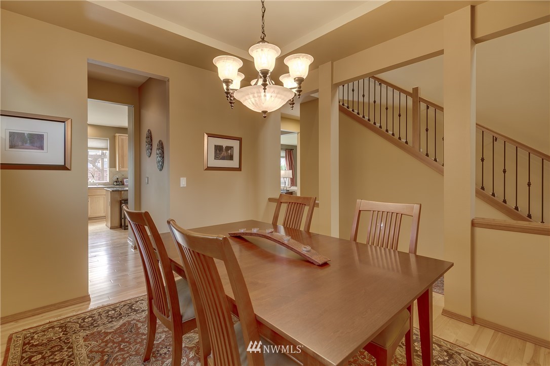 21105 1st Avenue West Bothell, WA 98021 - Photo 8 of 40 a view of a dining room with furniture and a chandelier