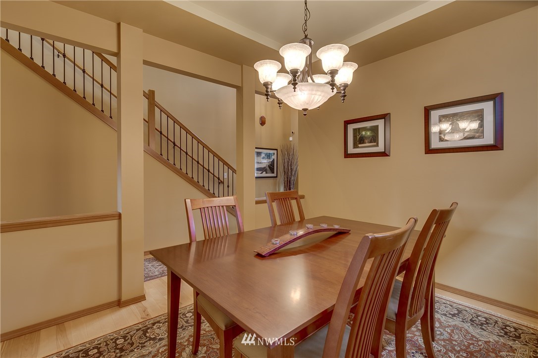 21105 1st Avenue West Bothell, WA 98021 - Photo 9 of 40 a view of a dining room with furniture and chandelier