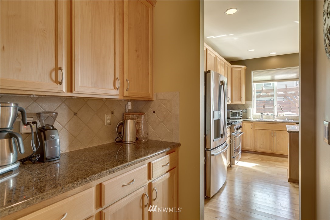 21105 1st Avenue West Bothell, WA 98021 - Photo 10 of 40 a kitchen with stainless steel appliances granite countertop a refrigerator and a sink
