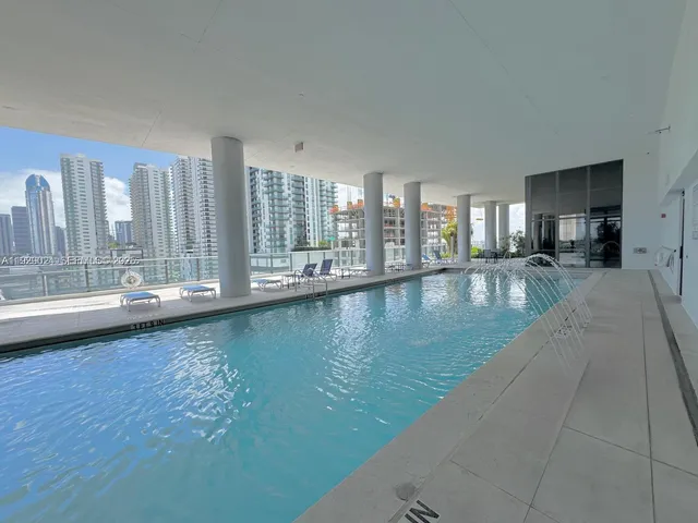 a kitchen with a stove and a chandelier