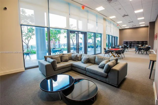 a view of a dining room with furniture and a floor to ceiling window