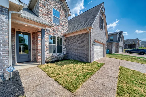 a kitchen with granite countertop a stove a sink and a microwave