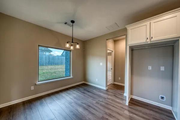 an empty room with closet and windows