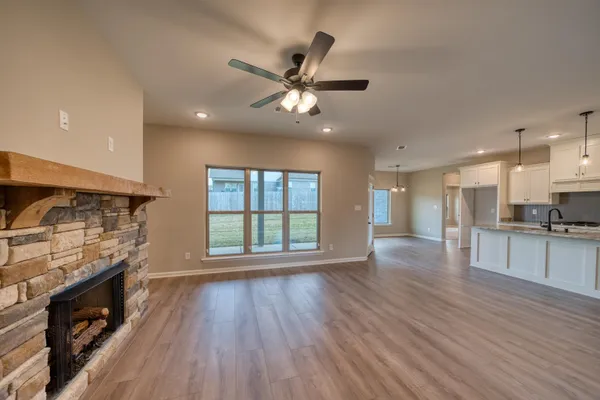 an empty room with closet and a ceiling fan