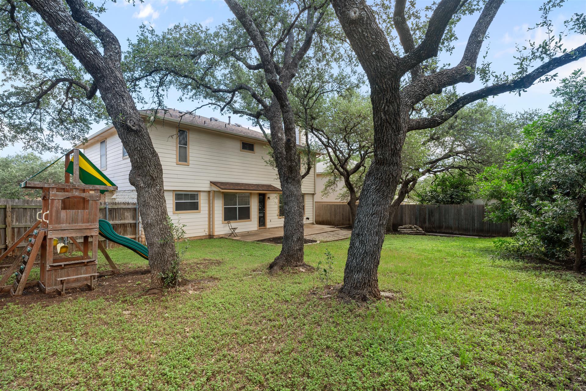1710 Persimmon Road Cedar Park, TX 78613 - Photo 31 of 33 A spacious fenced backyard - ideal for kids and your four-legged family members. So many beautiful Live Oak trees.