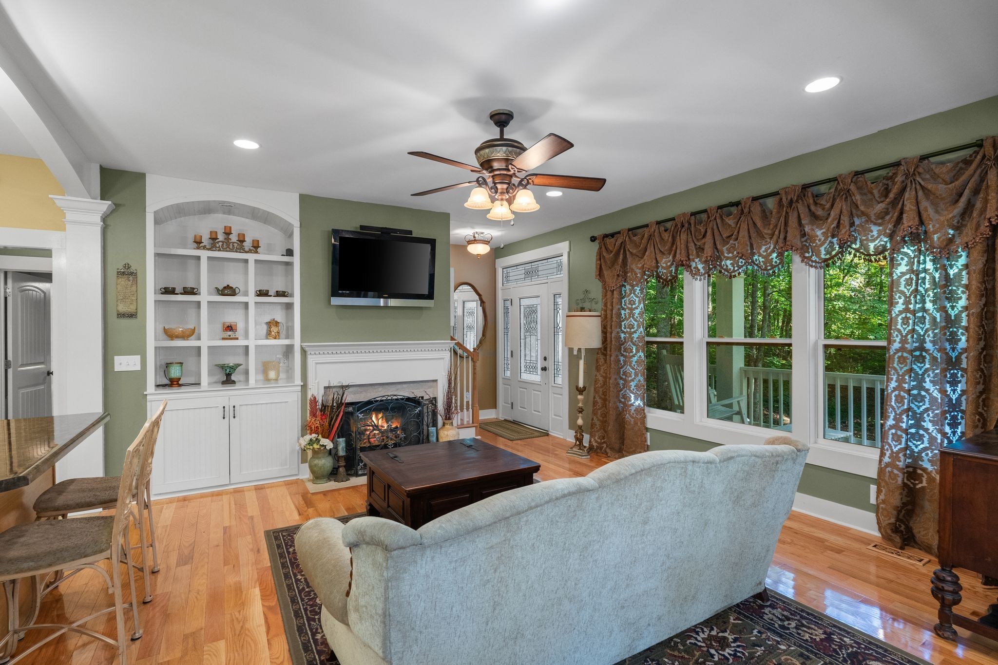 2504 Bearwallow Road Ashland City, TN 37015 - Photo 13 of 48 a living room with furniture a fireplace and a flat screen tv