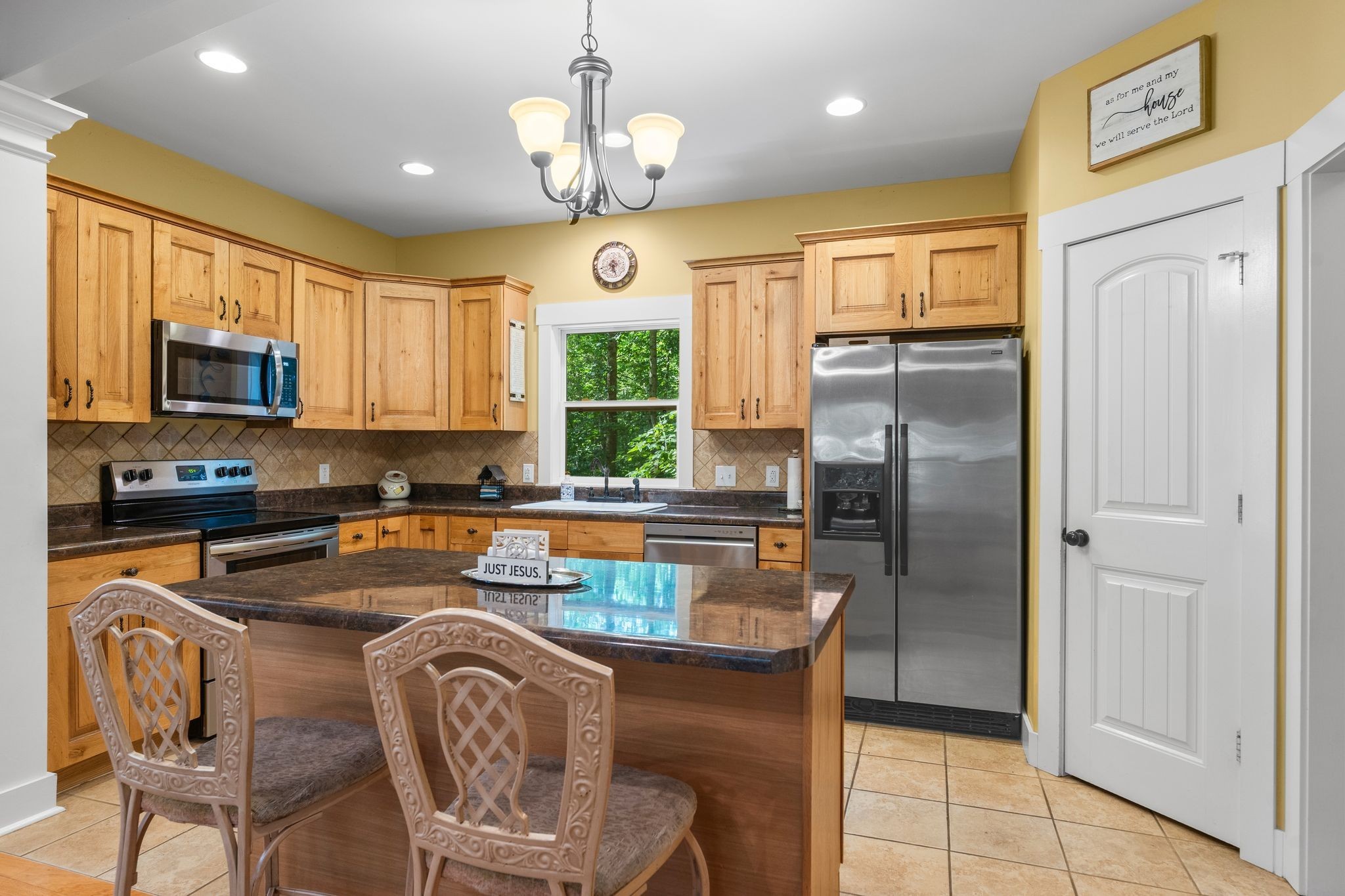2504 Bearwallow Road Ashland City, TN 37015 - Photo 15 of 48 a kitchen with stainless steel appliances granite countertop a refrigerator a stove top oven a sink a dining table and chairs with wooden floor