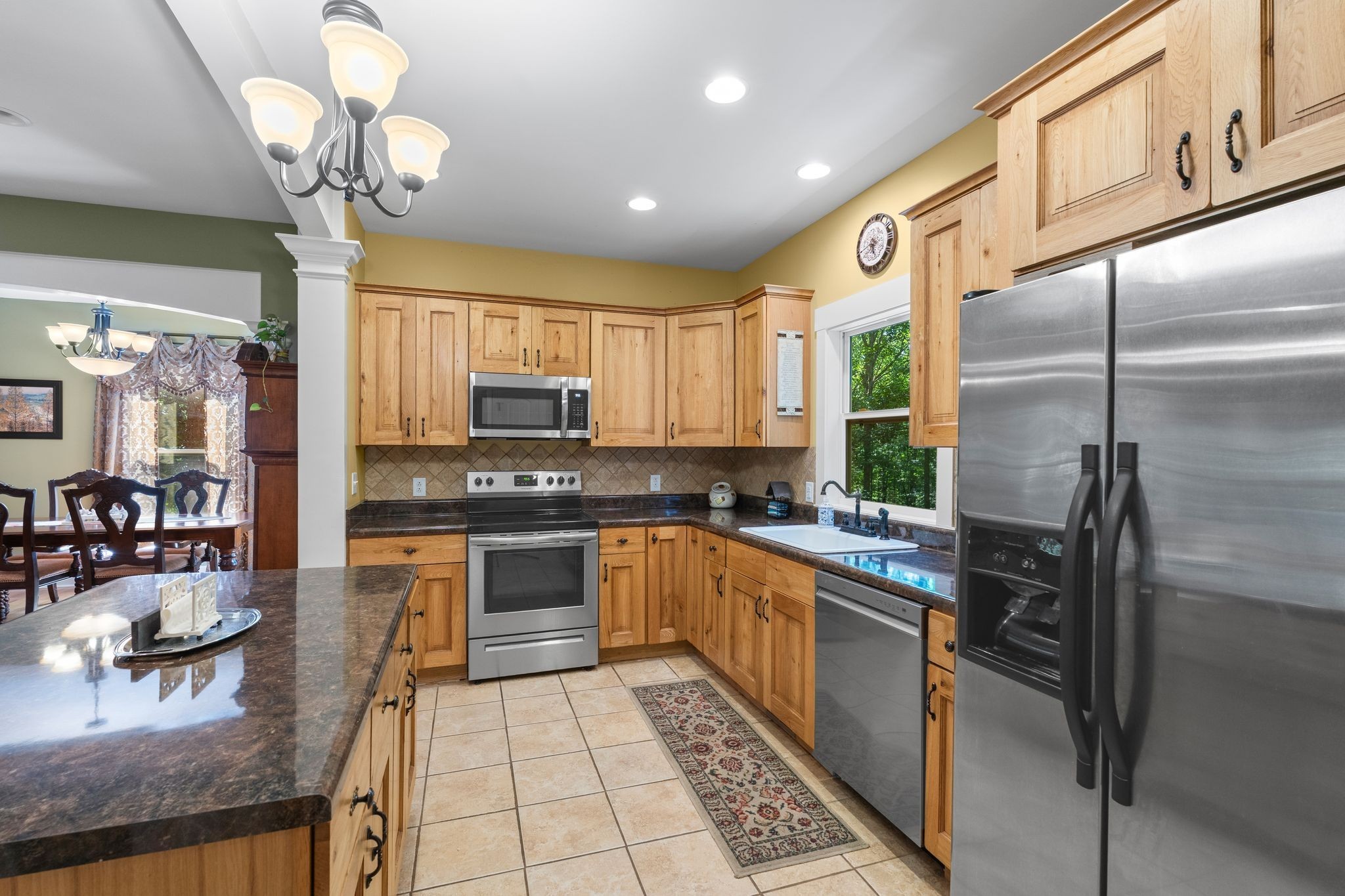 2504 Bearwallow Road Ashland City, TN 37015 - Photo 16 of 48 a kitchen with stainless steel appliances granite countertop a refrigerator a sink dishwasher a stove and white cabinets with wooden floor