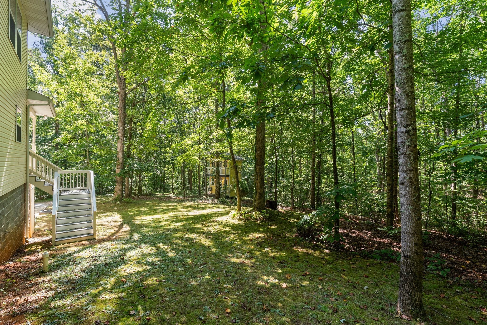 2504 Bearwallow Road Ashland City, TN 37015 - Photo 40 of 48 a backyard of a house with lots of green space and outdoor seating