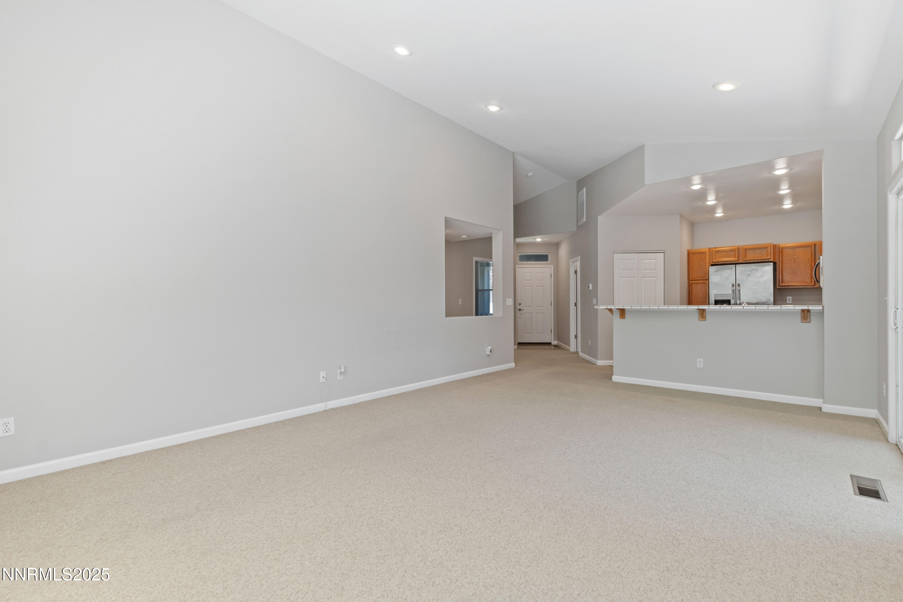 860 Caughlin Crossing Reno, NV 89519 - Photo 6 of 21 an empty room with a kitchen and a sink