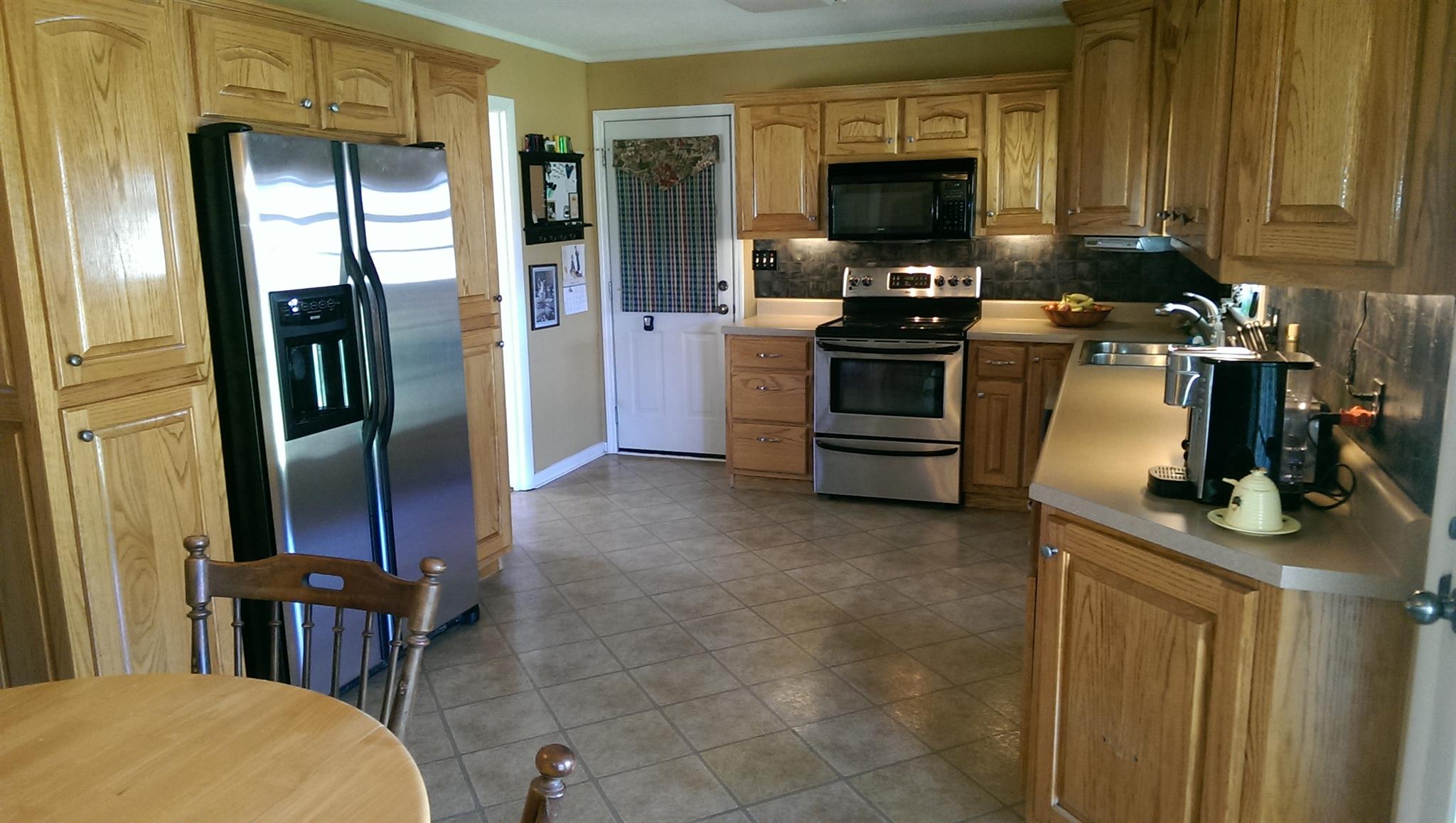 1801 Ann Road Lawrenceburg, TN 38464 - Photo 3 of 10 a kitchen with stainless steel appliances granite countertop a refrigerator and a stove top oven