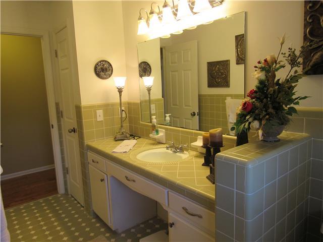 1801 Ann Road Lawrenceburg, TN 38464 - Photo 7 of 10 a bathroom with a granite countertop sink a mirror and shower