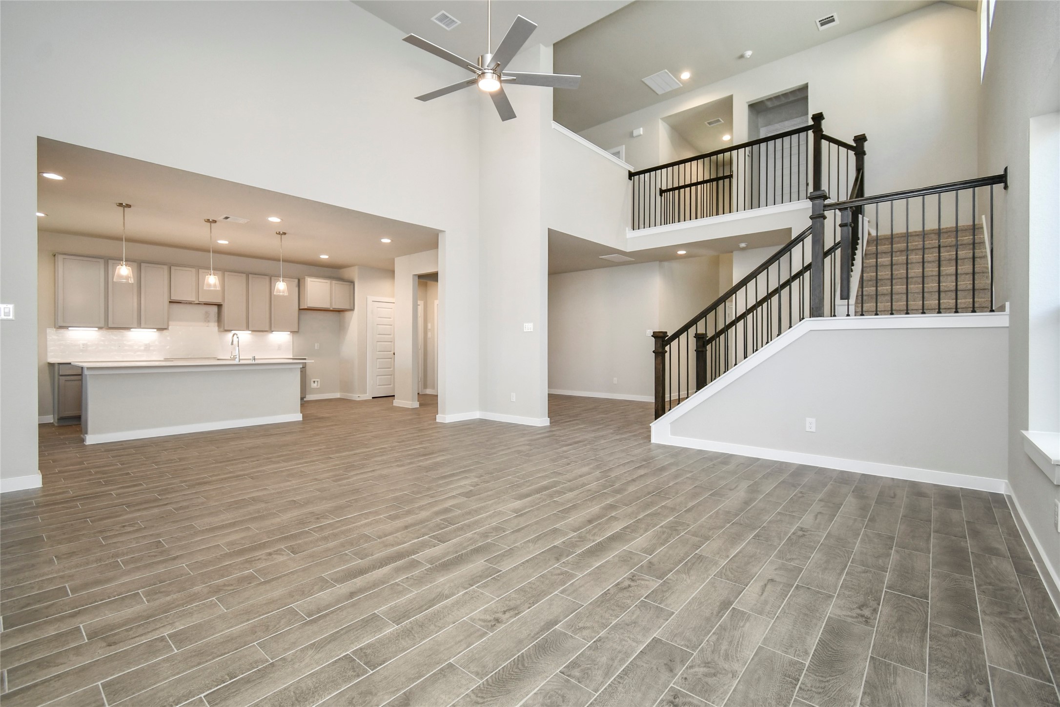 15207 Statice Trail Houston, TX 77044 - Photo 14 of 24 a view of staircase and kitchen with sink