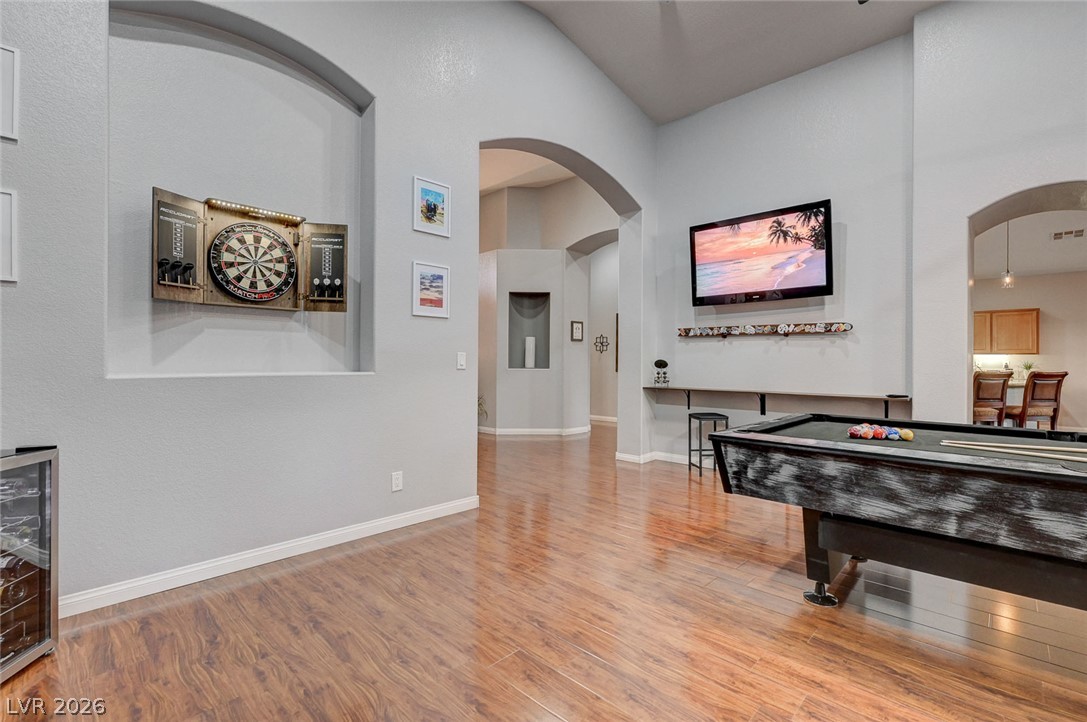 1604 Cattle Ranch Place Henderson, NV 89002 - Photo 16 of 99 Elegant arches and rich hardwood flooring define this inviting recreation room.