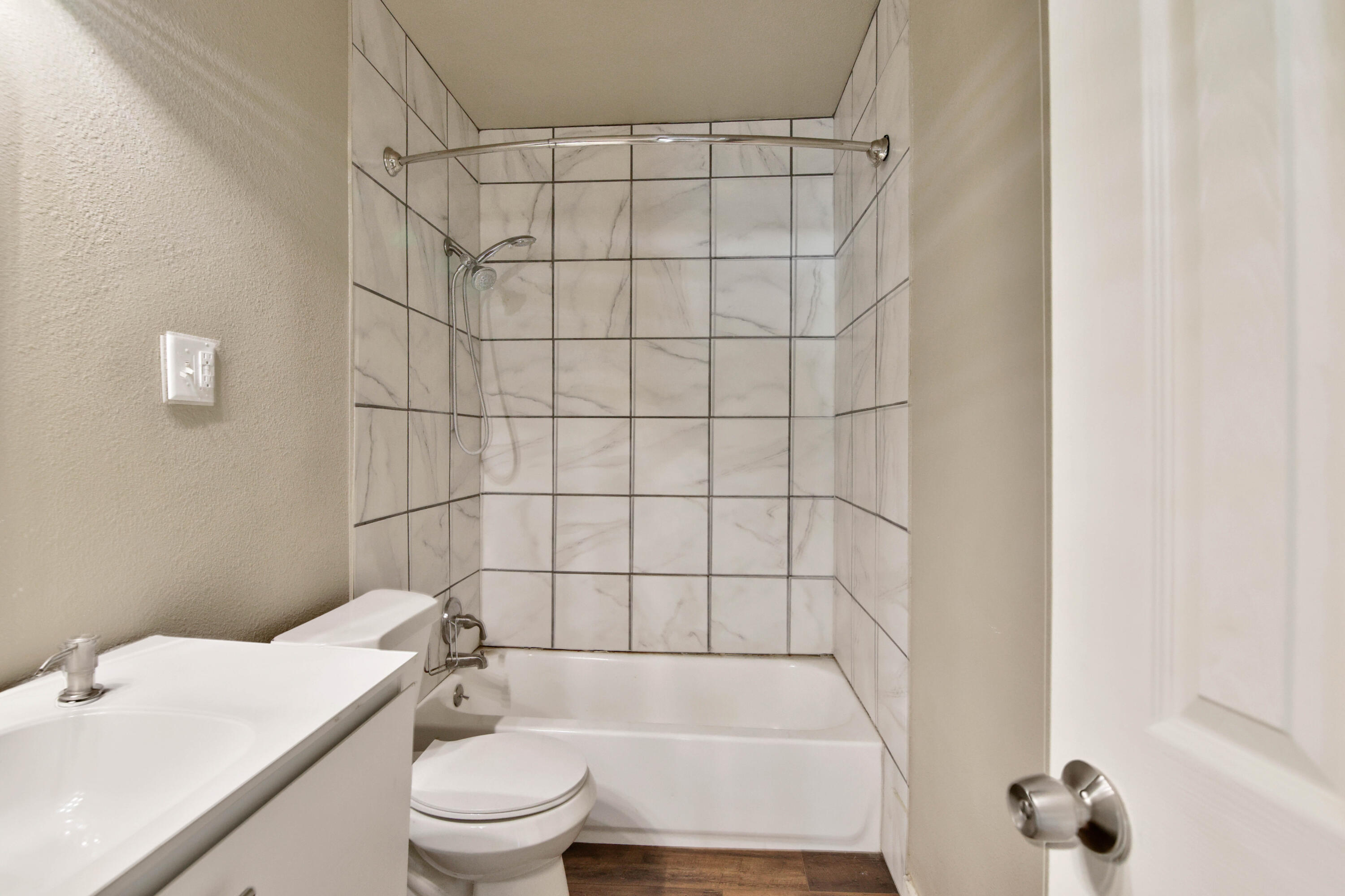 2408 24th Street Lubbock, TX 79411 - Photo 11 of 32 a bathroom with a toilet and a shower