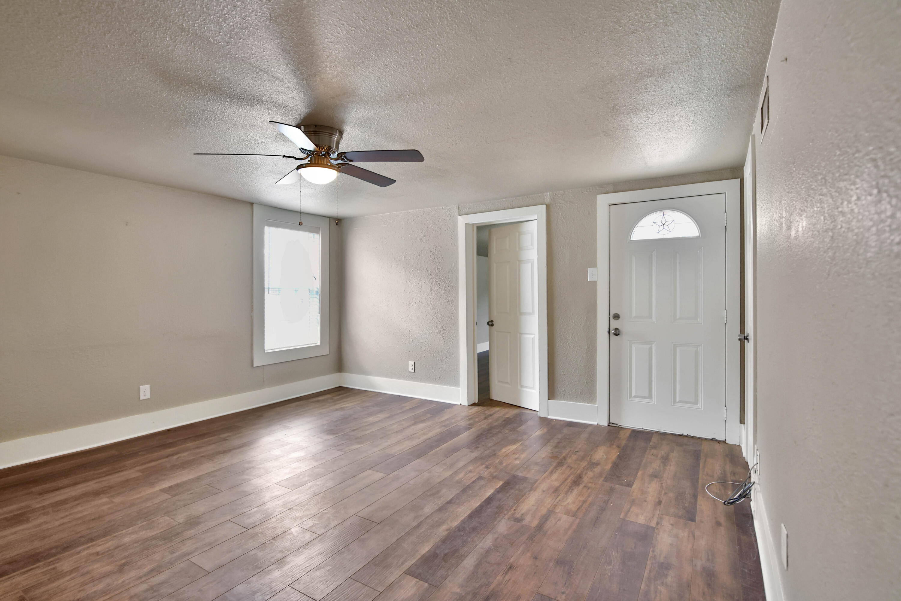 2408 24th Street Lubbock, TX 79411 - Photo 12 of 32 wooden floor in an empty room with a window