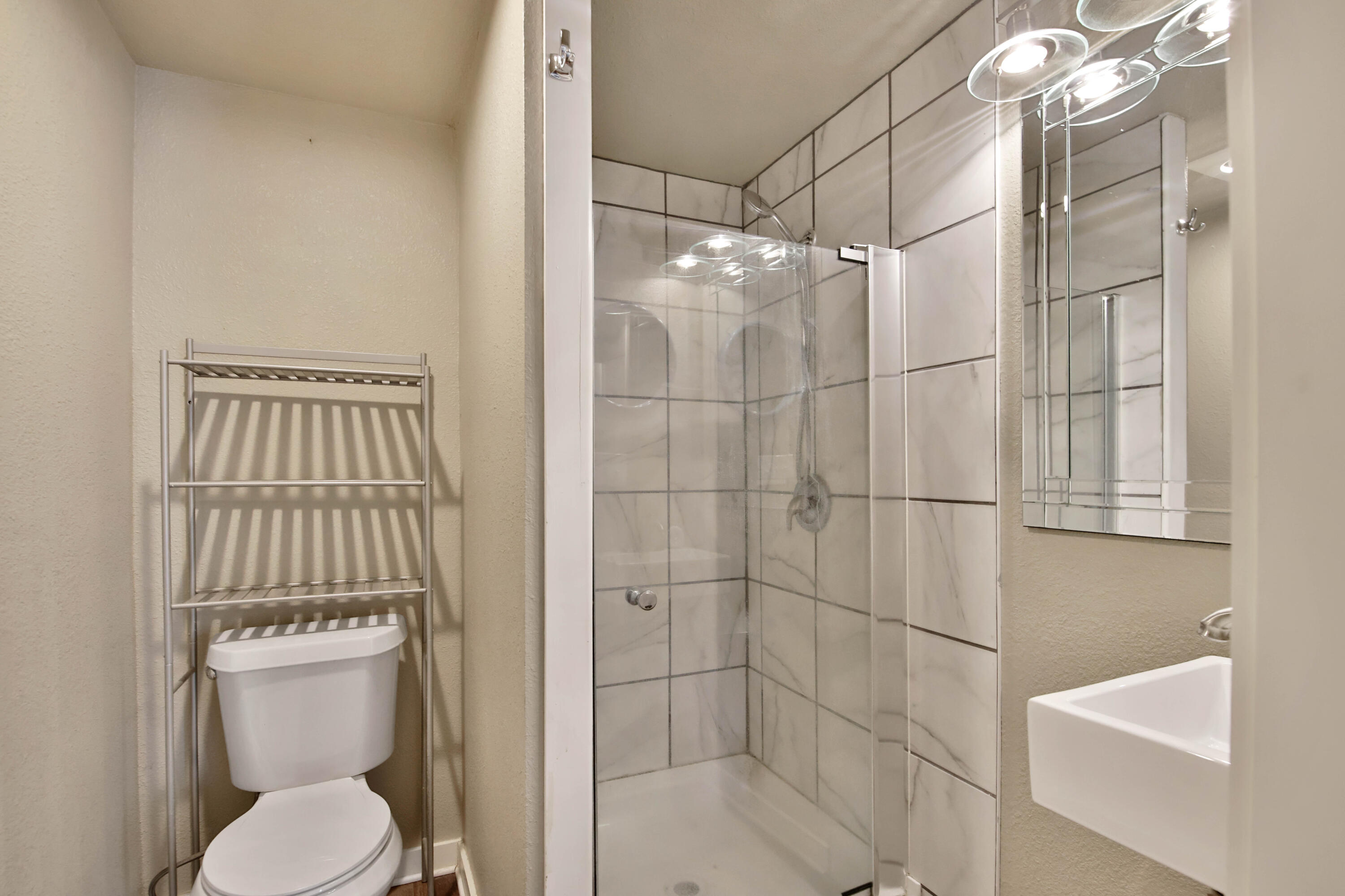 2408 24th Street Lubbock, TX 79411 - Photo 13 of 32 a bathroom with a toilet and shower