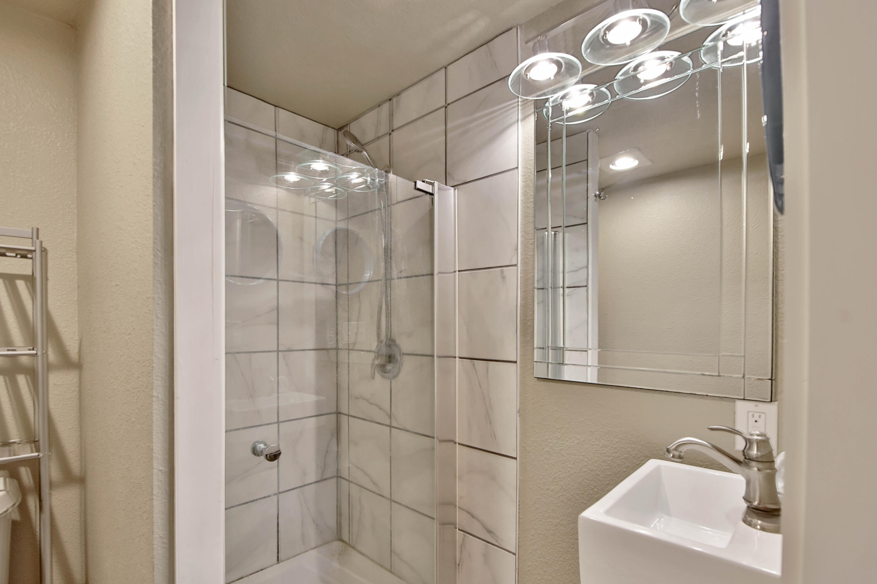2408 24th Street Lubbock, TX 79411 - Photo 14 of 32 a bathroom with a sink vanity and a mirror