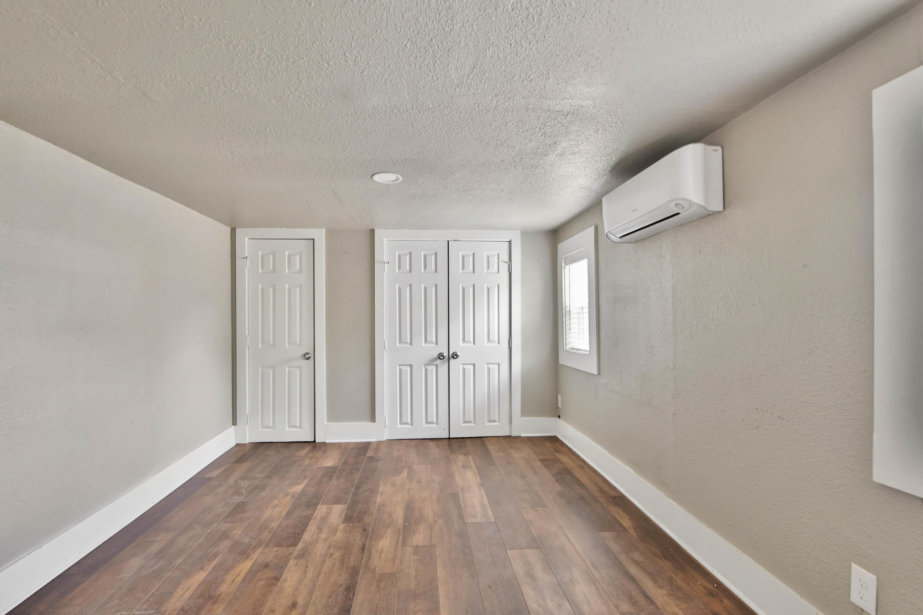 2408 24th Street Lubbock, TX 79411 - Photo 17 of 32 a view of hallway with a large window and wooden floor