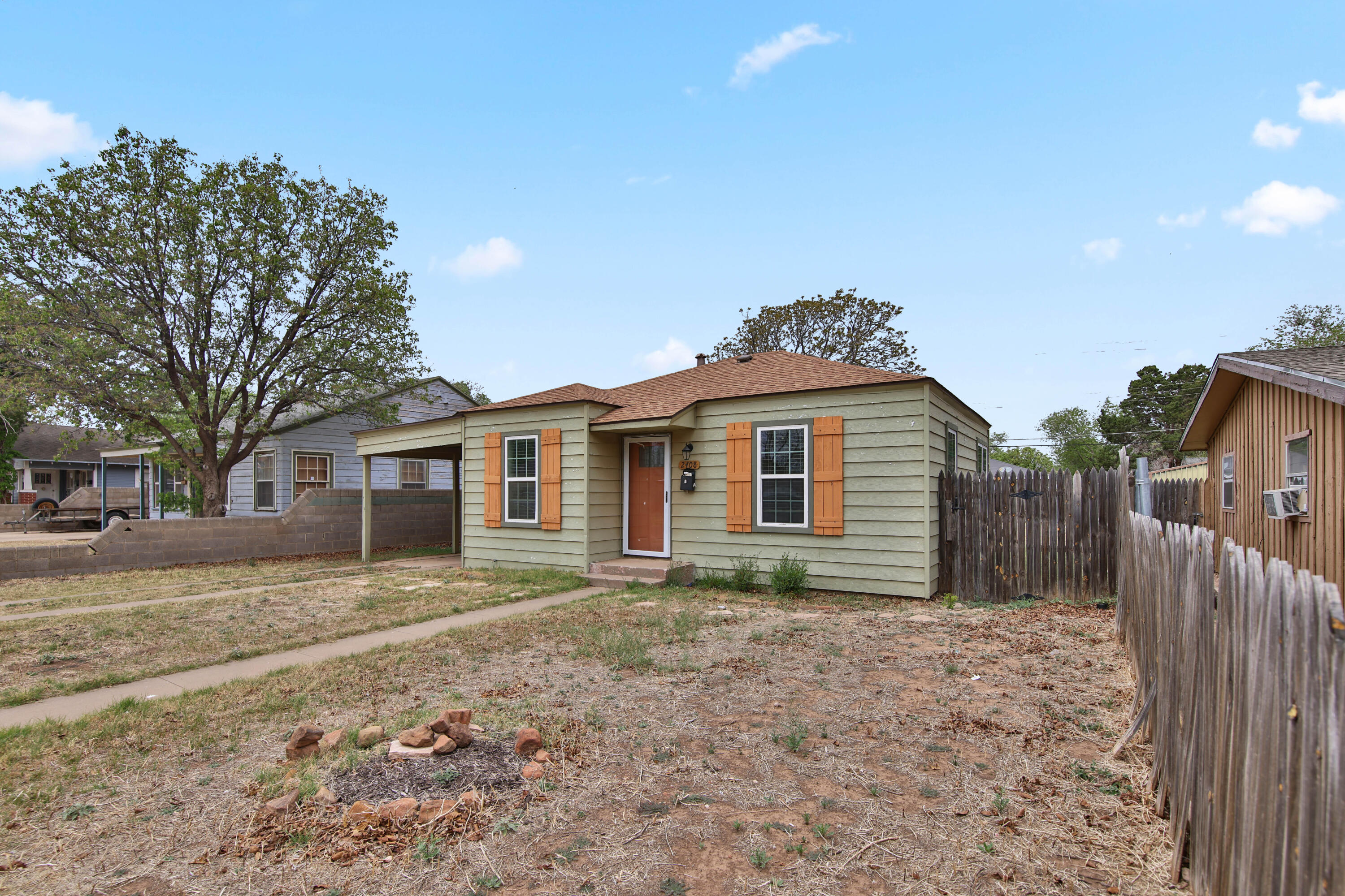 2408 24th Street Lubbock, TX 79411 - Photo 2 of 32 a front view of a house with a yard