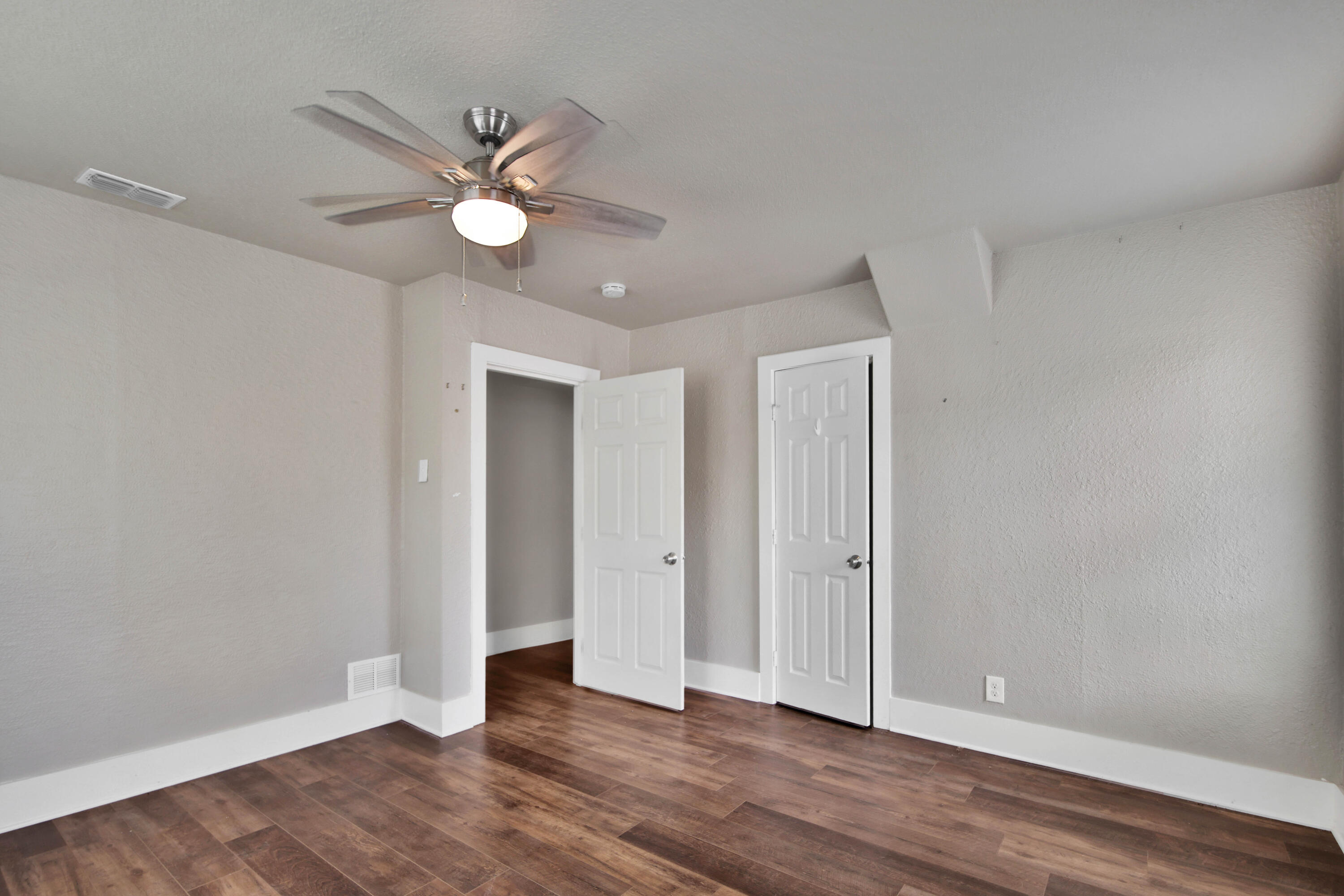 2408 24th Street Lubbock, TX 79411 - Photo 24 of 32 an empty room with wooden floor fan and windows